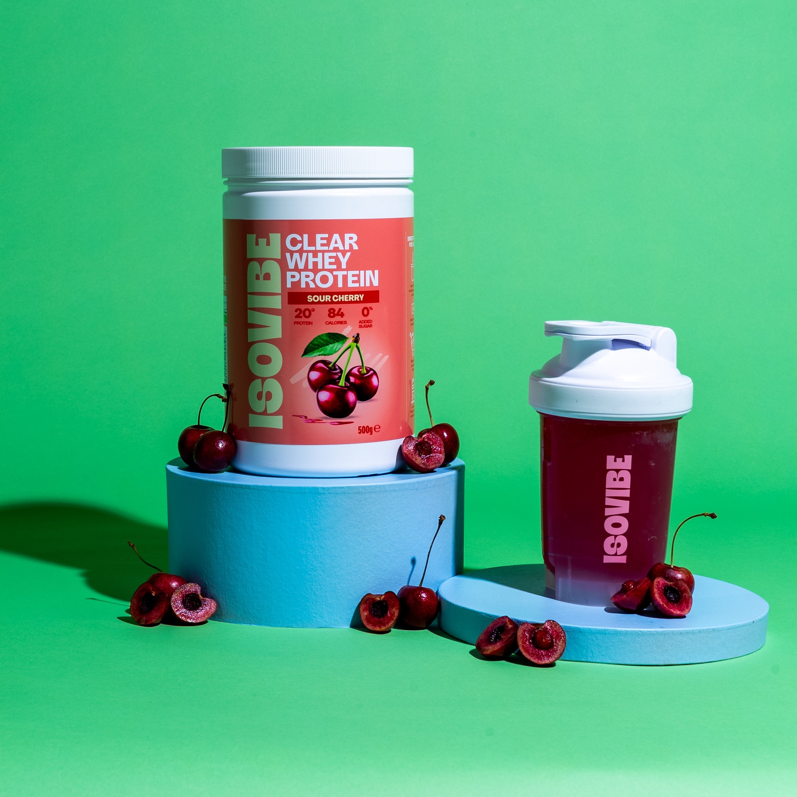 ISOVIBE shaker with Sour Cherry on podium with tub and cherries