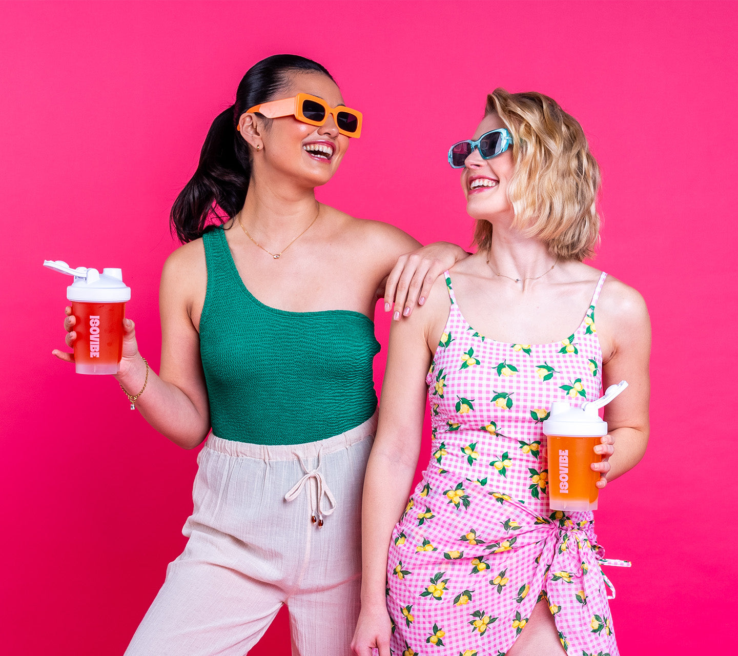 peach and raspberry isovibe drink being enjoyed by a pair of friends 